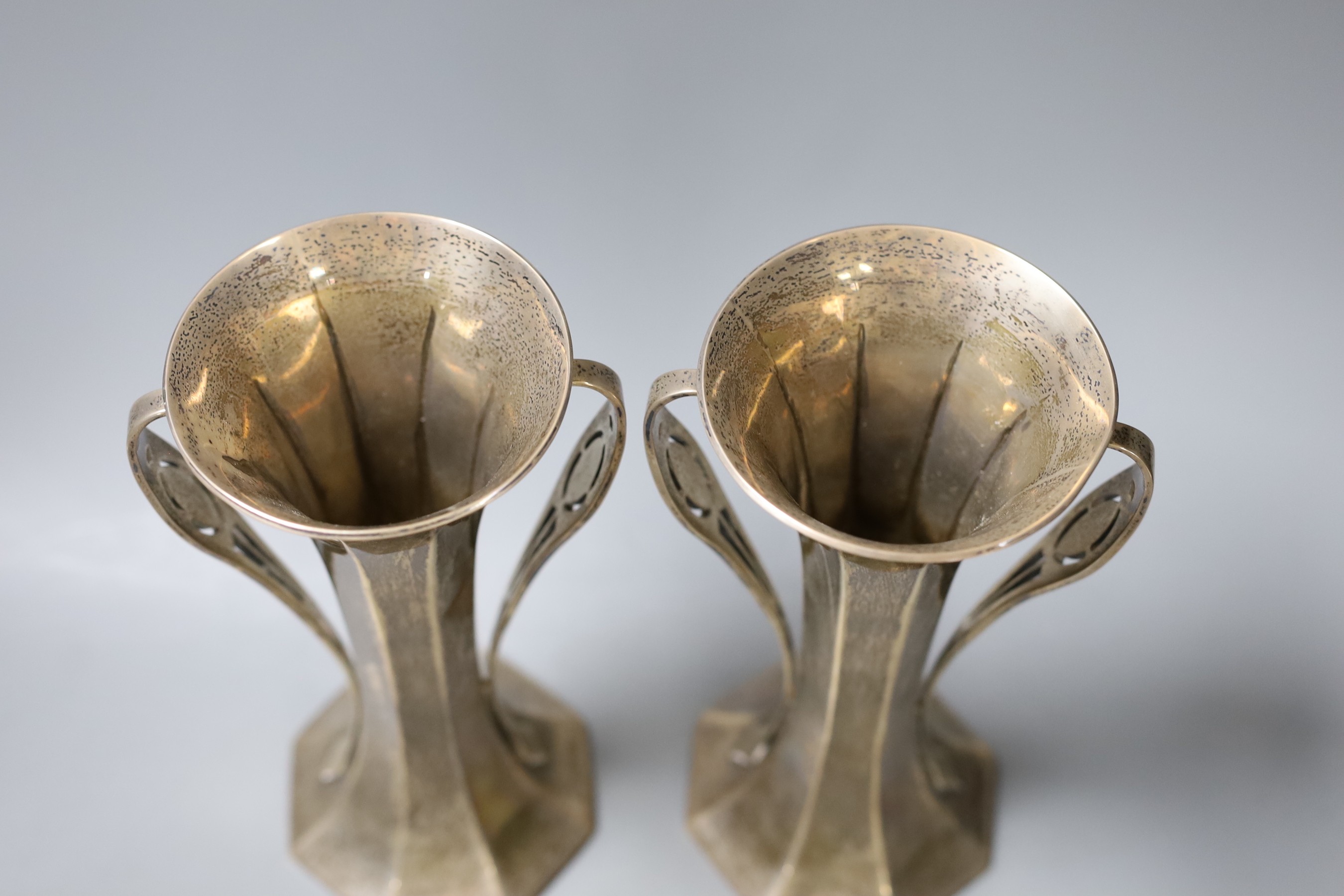 A pair of Edwardian Art Nouveau silver two handled vases, by Goldsmiths & Silversmiths Co Ltd, London, 1903, height 20.7cm, gross 22.2 oz.